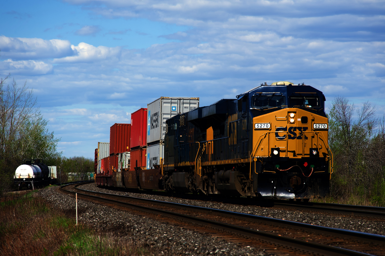 After switching to 100% CN power for about six months, CSX power returned to run-through trains CN 326/327 about three weeks ago. Here a repainted ES40DC leads CN 327 around a curve as it approaches Coteau, where it will leave the Kingston Sub for the Valleyfield Sub. At left are a few cars going to or from Ronsco.