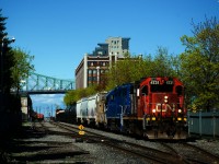 CN 500 has its caboose tucked behind the power as it departs the Port of Montreal. It had been delayed in leaving as the journal on the crews tablet was not updating to show the three dangerous cars in their consist.