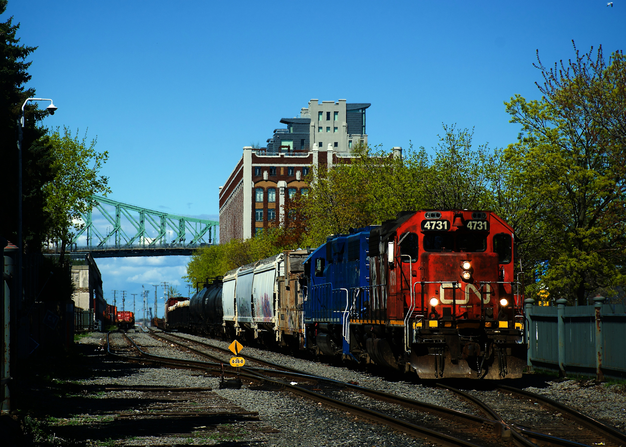 CN 500 has its caboose tucked behind the power as it departs the Port of Montreal. It had been delayed in leaving as the journal on the crews tablet was not updating to show the three dangerous cars in their consist.