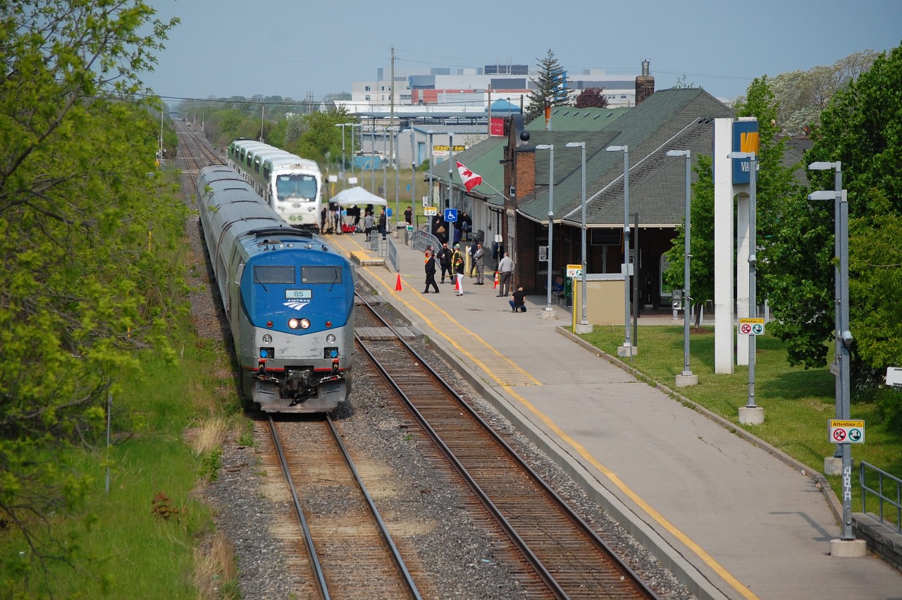 VIA 97 with AMTK 85 was meeting an special GO Train at St. Catharines this morning for a GO Announcement being held at the station on the platform.