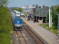 VIA 97 with AMTK 85 was meeting an special GO Train at St. Catharines this morning for a GO Announcement being held at the station on the platform. 