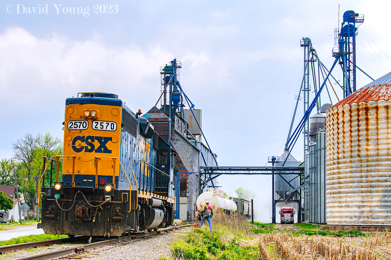 A busy scene at the elevator in Tupperville, Ontario. Grain dust fills the air as a transport takes on a load of area grain. The conductor of D924 has bent the iron to gain access to the last customer serviced by CSX on the former C&O Sub 2 south of Sarnia to exchange the four grain loads with four empties. CSX ceased service through here in October 2013 and the rails have remained silent ever since.