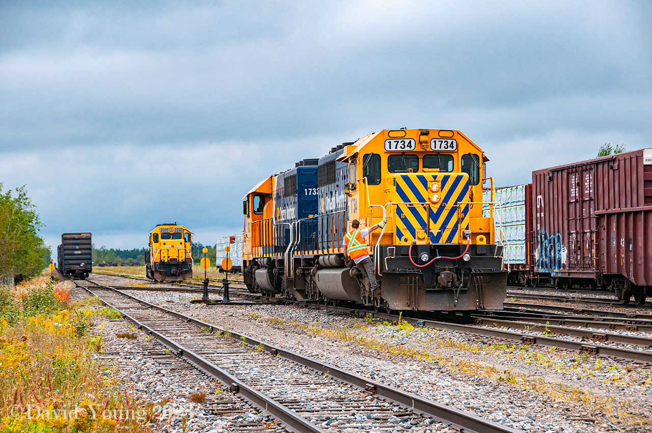 The Hearst yard engine (ONT 2200) has cleared after building 516's outgoing train, seen to the left. Having cut off their inbound train from Cochrane(pictured here), the set of SD40-2's prepare to nose onto their train while the yard helper hitches a ride to normal the crossover switches. After switching engines and cutting in the brake line, 516 will be on the move "south" out of town, bound for Cochrane. The Hearst engine will couple up and begin to disassemble the inbound 313 consist before continuing the tasks of servicing the local industries.