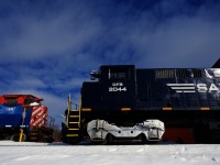 CFS 2044 is passing CFS 641 just outside a newly constructed shop as the Sartigan's chief mechanical engineer looks on with pride. CFS 641 is being used as a parts source.
