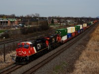 Freshly rebuilt CN 3315 leads a long CN X123. Barely visible in the distance is the tail end of CN 372.