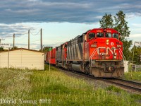 Thunder Bay to Fort Frances freight CN 437 is making good time through the small town of Kakabeka Falls with a duo of veteran cowls in the lead. Passing the razed station site of the station, replaced with a mundane shack used for MoW employees decked out in that lovely beige siding. The double station name signs framing both sides of the main herald  back to better times with this section of right of way was double tracked. For those keeping track power was behind the lead SD60F was sister CN 5533. Behind them, a pulp car destined for pulp load out at the back track at Annex.