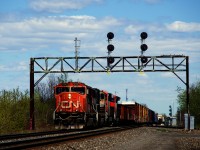 CN 369 has a pair of SD75Is then a pair of GEVOs as it passes underneath a classic signal bridge at the turnout for the Valleyfield Sub (at right).