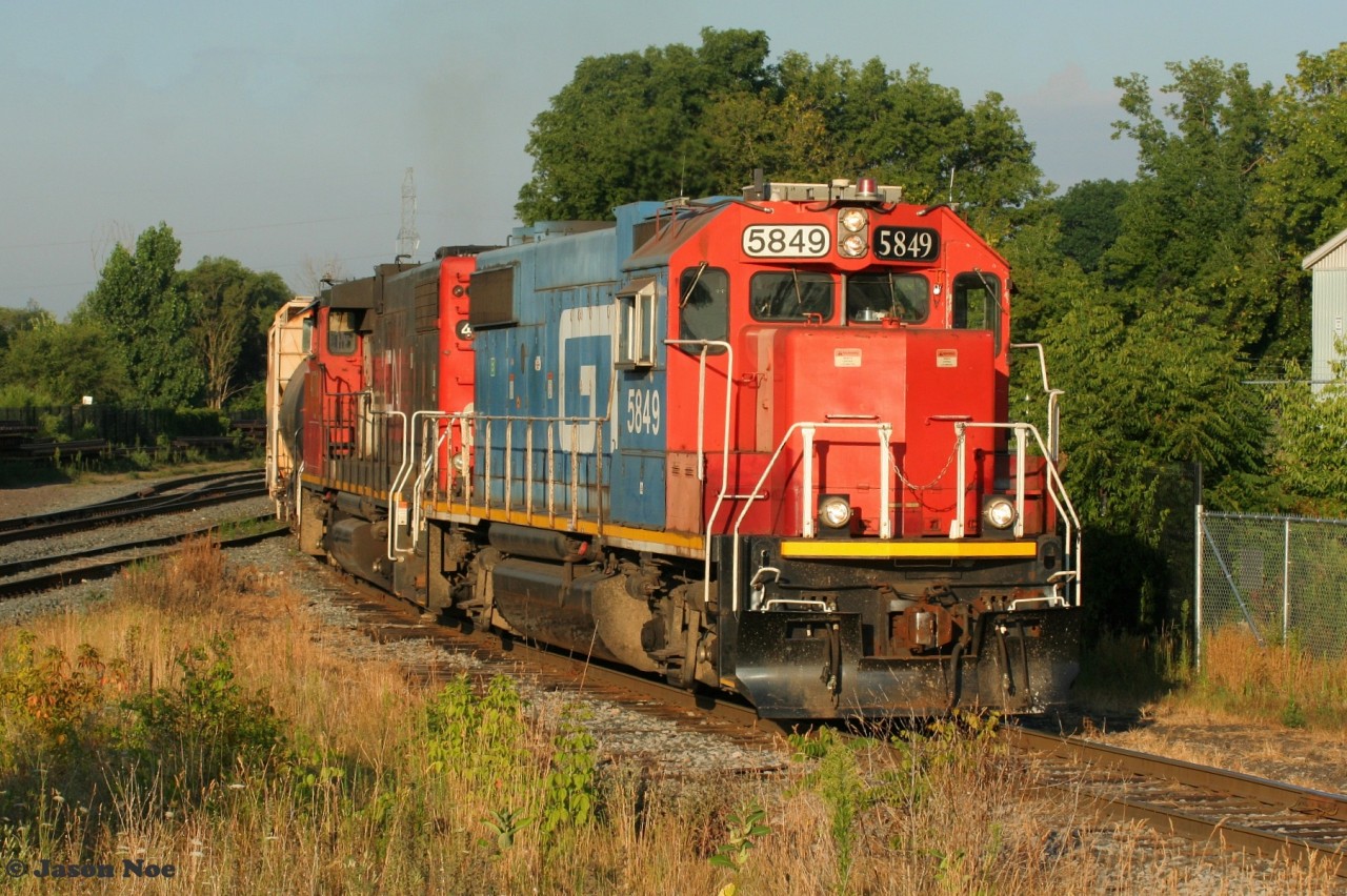 CN L542 with GTW 5849 and CN 4770 have just started their day and are seen approaching Alma Street in Guelph, Ontario with cars for the North Industrial Spur.