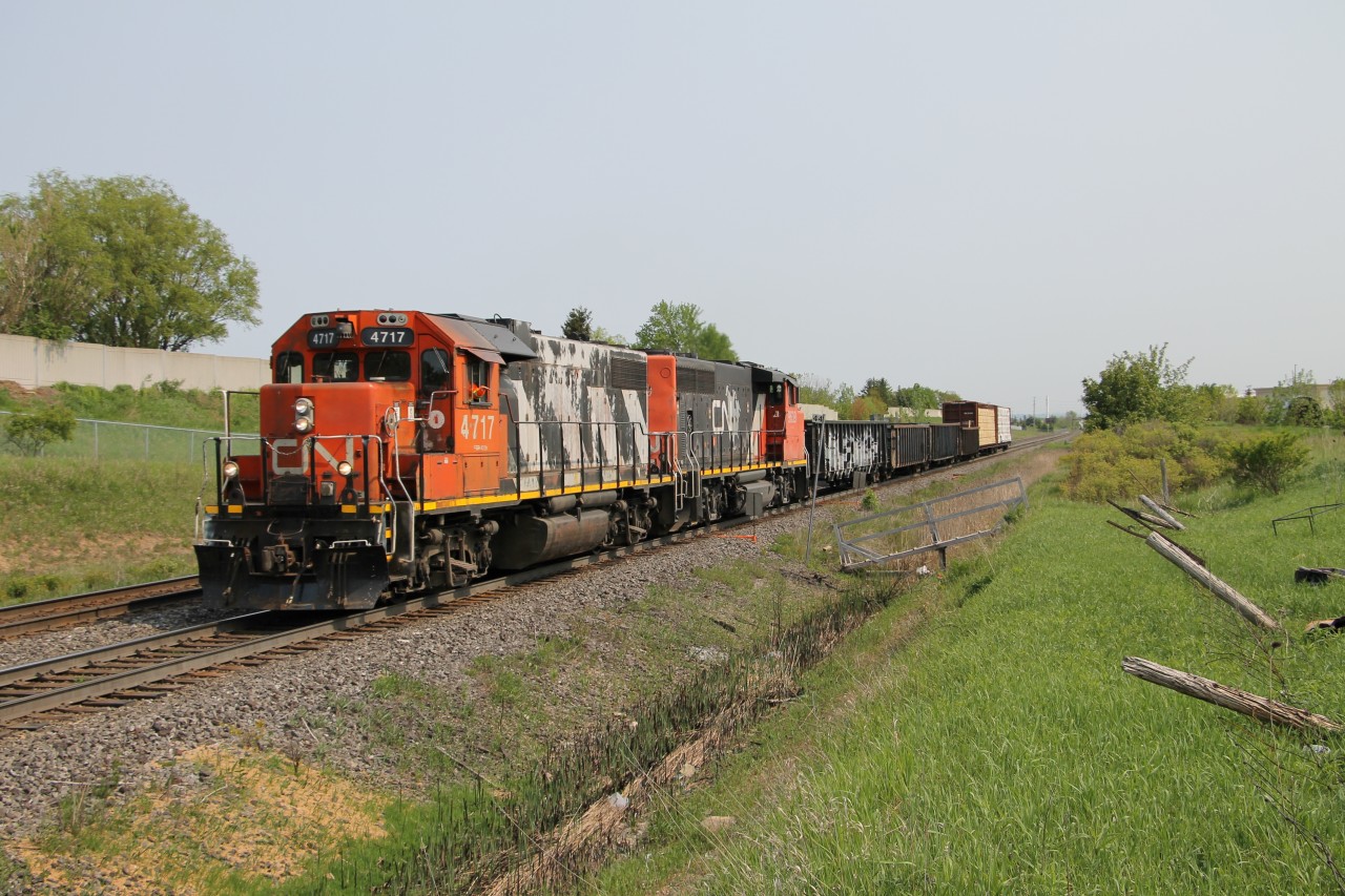 L551 with CN 4717 and CN 9639 has a short train today, four gons and two lumber loads as it heads east toward Tansley for a meet with a west bound.