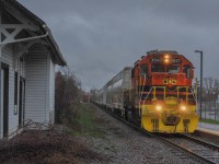 On April 23, 2023, the EMD GP38-2 recently purchased by the company leads train 504 from Saint-Martin JCT. The train is now heading towards the main yard. You can also see, on the left, the former Sainte-Thérèse CPR station.