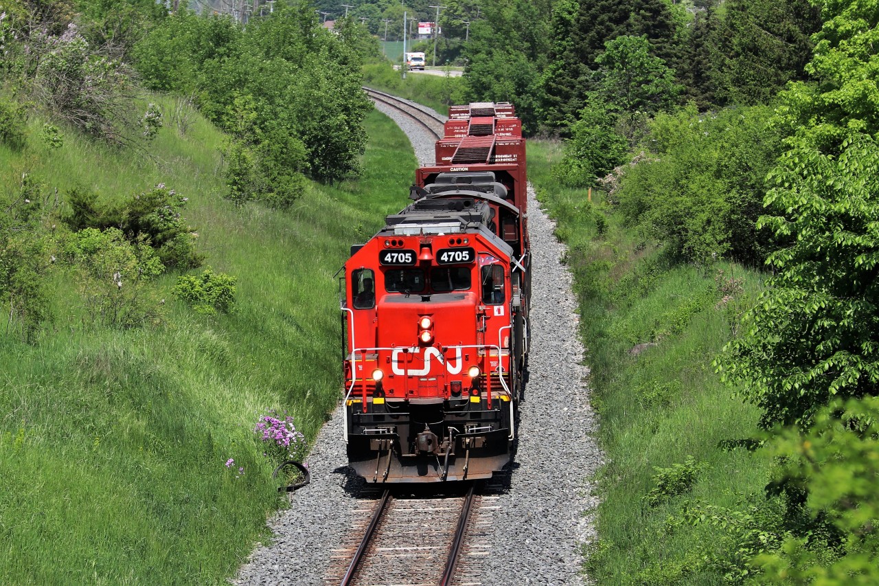 After finishing their drop in Acton and waiting for the passing westbound GO, CN 4705 with CN 7068 fly under the Jones Baseline overpass on their way back to the Guelph Yard. The GP38 was making terrific time with the 3 car load. This location is tough as well with traffic right on your heels and a large Bell telephone line running through the air at picture height.
