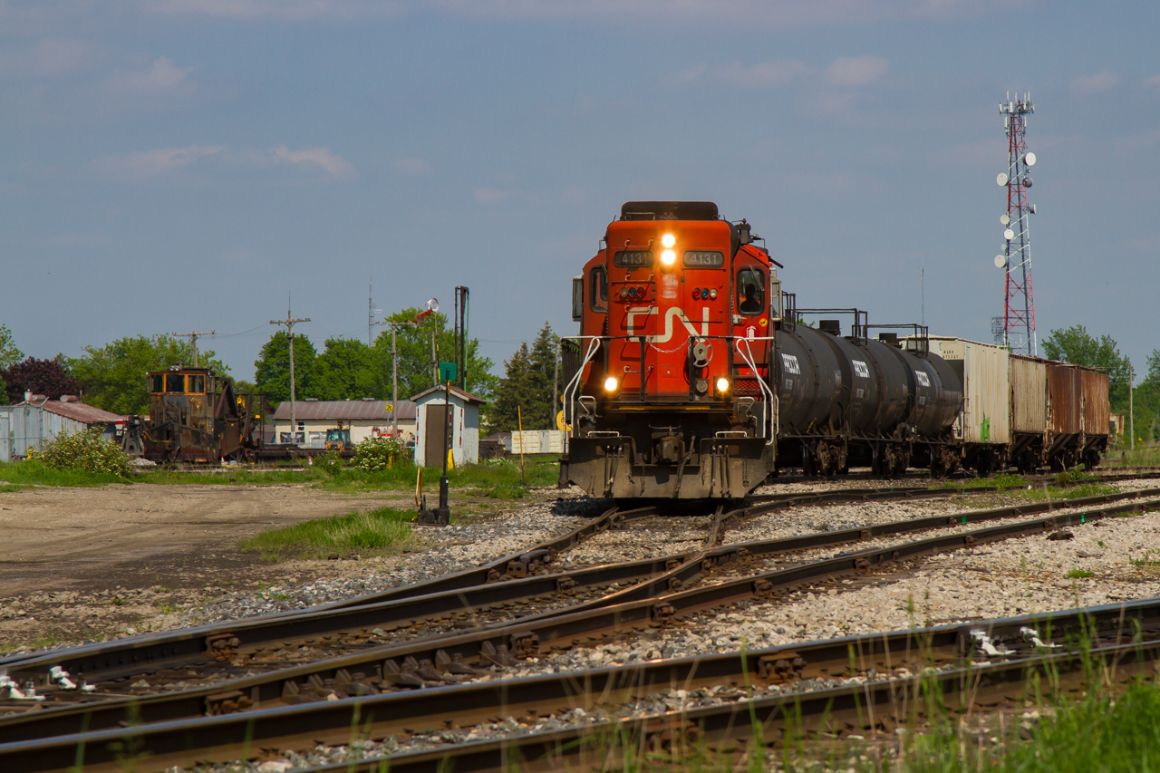A warm May day last year brought me out to Stratford, ON, where after following 568 from Kitchener with RLK 4095 in tow (set off just before this frame), they are now seen putting together their outbound train for customers further down the line towards Pottersburg. They are pictured here running up the ladder track, framed beside Jordan spreader CN 50948, which has spent the last year and a half resting away in the MOW tracks after the ill-fated work extra last year. Full consist that day into Stratford was CN 4131- CN 9427- CN 7521 - RLK 4095 and a measly single tank car.