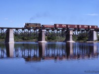 Continuing west from its <a href=http://www.railpictures.ca/?attachment_id=51855>meet at Canfield,</a> extra 3875 west rumbles across the Grand River at Cayuga.<br><br><i>Scan and editing by Jacob Patterson.</i>