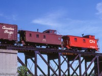 A surprise on the tail end of <a href=http://www.railpictures.ca/?attachment_id=51925>extra 3875 west</a> as it crosses the Grand River at Cayuga, N&W caboose 2607 appears just ahead of CN van 76048.<br><br><i>Scan and editing by Jacob Patterson.</i>