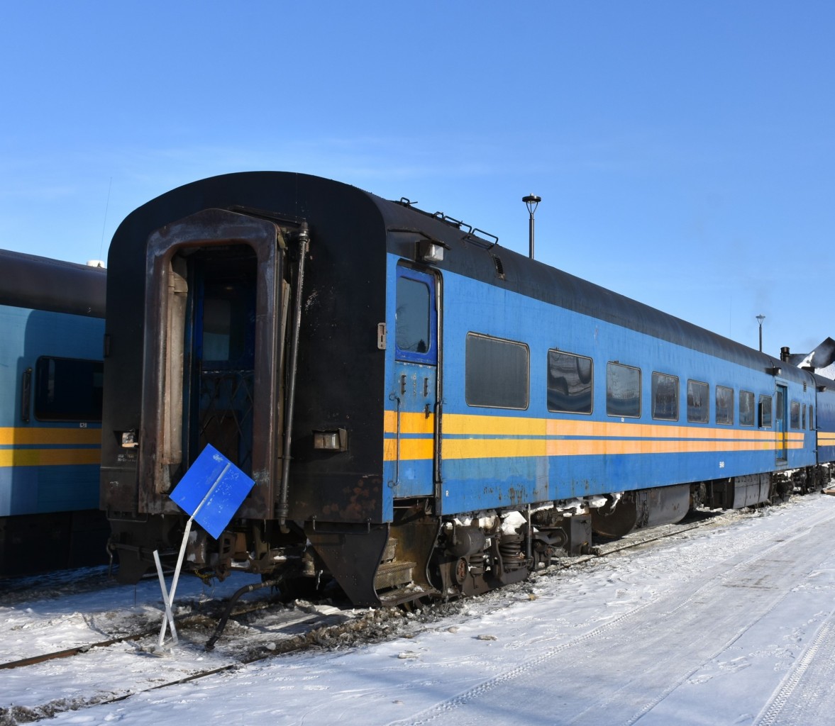 One of the two ex-VIA/exx-CN passenger cars on KRC's #291 The Pukatawagan Mixed on March 16, 2023, was KRC 5649 (ex-VIA 5649, exx-CN 5649) Class PB-79-A, 79 foot First Class car. It was built by CC&F in 1954, and converted to it's current baggage/coach configuration in 1998. 
Prior to being placed behind the locomotives for today's departure, KRC 5649 sits at the south end of The Pas station plugged in to wayside power and coupled to baggage car KRC 9631 .