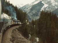 After exiting the Lower Spiral Tunnel and with the top half of the vestibule door open I am enjoying the mountain view, the smell of mountain air and occasional diesel exhaust as VIA #1 "The Canadian" has a Clear Signal at Cathedral (East) descending the 2.4% grade on The Big Hill toward Field BC.