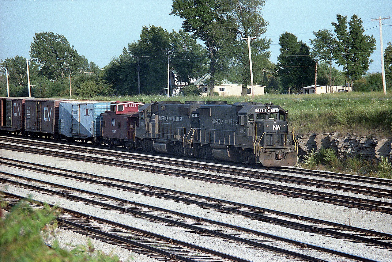 I'm on the opposite side from Bowen Road in Fort Erie near CN Duff, where I crossed. Did not shoot from here very often.  This is late day, and NW 4160, 4161 (nice to see consec numbers!) with train ready to depart westbound. Don't recall other times when I noted a caboose, (#518567) behind the power so not sure if this is the thru train to Detroit but the time of day was right.
Behind the caboose, the "I Love NY" boxcars were a popular sighting feature back then, especially on the D&H.