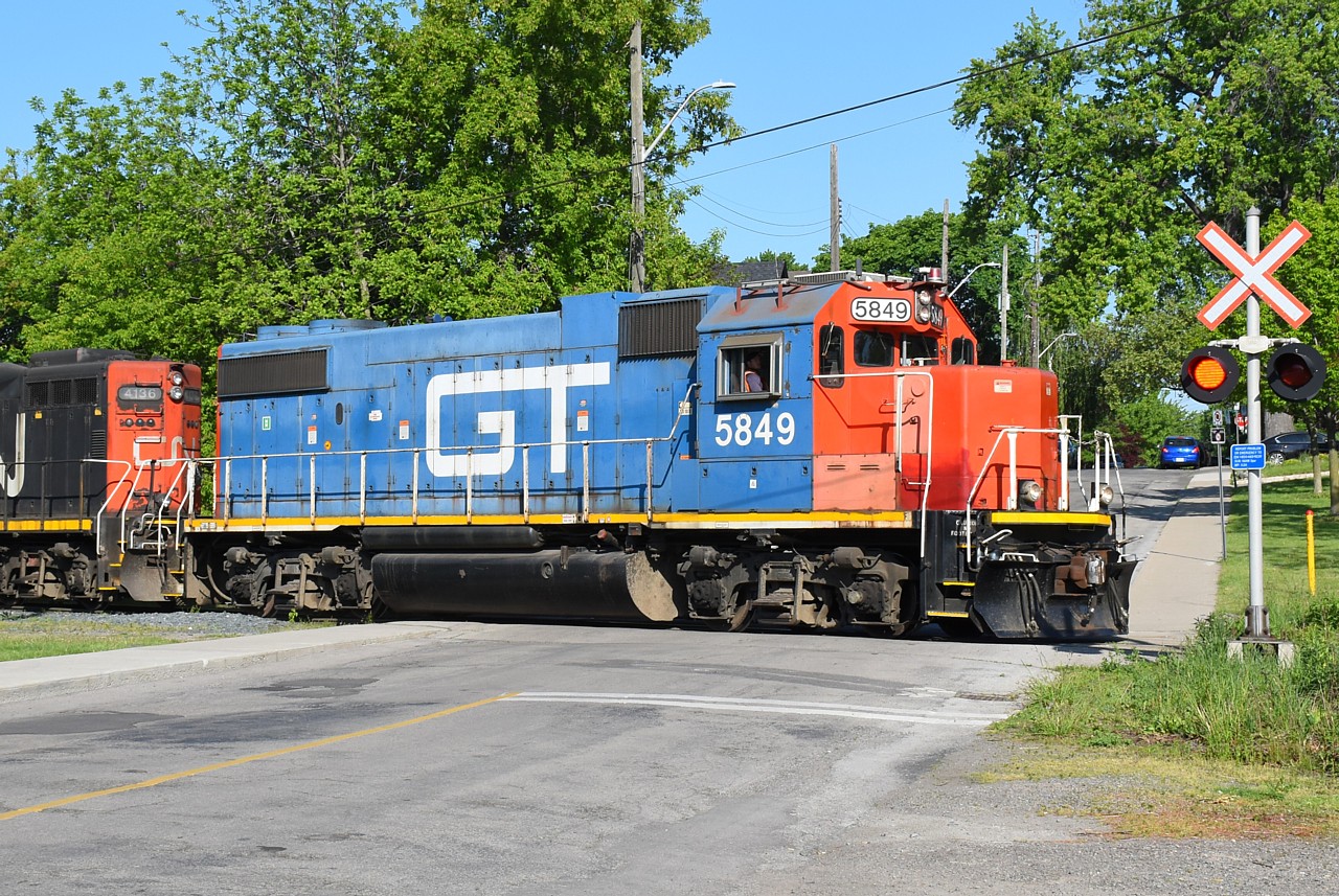 GTW 5849 leads the 07:00 job "down the hole", crossing Simcoe Street East on the N&NW Spur on their way to spend the morning switching north end Hamilton industries.  In true Hamilton fashion, I spent a good length of time kicking garbage out of the shot, only to have a homeless dude show up and park his shopping cart right in the way.  Thankfully, he allowed me to relocate his worldly possessions so I could get the photo and not interrupt his scavenging.