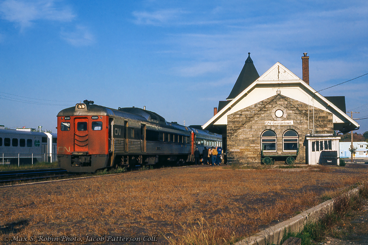 CN 665 makes its 1702h station stop at Georgetown with RDC-3 6351 in the lead.  Single level GO Transit equipment can be seen across the mainline while the old south platform edge is still seen at lower right.Max S. Brown Photo, Jacob Patterson Collection Slide.