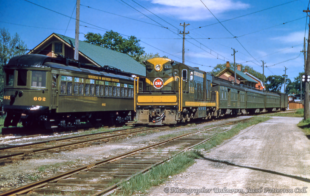 Closing in on seventy years since this scene was captured, Montreal & Southern Counties interurban car 602, built by National Steel Car in 1913, sits on the station track at Marieville while Canadian National train 705 from Granby led by CLC H-10-64 7615 pulls away from the station (note order board above coaches) at 14:35h bound for Montreal.Passenger service over the Granby Sub was nearing an end by this time.  Originally constructed by the Montreal, Portland & Boston Railway during the 1870s, and operated under the South Eastern Railway name, the line began service in 1877 between Longueuil and Felighsburg via Marieville and Farnham.  The line came under control of the Central Vermont in 1891.  The CV would later come under control of the Grand Trunk Railway in 1896.  The Montreal & Southern Counties Railway, founded 1897 and under GTR ownership in 1906, consisted of two divisions; the Suburban and Interurban.  The Interurban Division ran east out of Montreal to Marieville and on to Granby, plus a branch from Marieville to Sainte-Angele-de-Monnoir with service opening to Marieville in September 1913.  The line would open to Granby in 1916, and the branch in 1926.  Electric operations would be cut back from Granby in 1951 seeing electric operations terminate at Marieville.  In their place, trains of conventional CNR equipment would operate via Marieville to Granby.  The M&SC's final run over the Interurban Division would take place on October 13, 1956, with the Suburban Division closing the following day.  CNR passenger service was down to one train each way per day by the end of the decade, ending April 29, 1961 as the new timetable came into effect the following day.  The Granby Sub (1978 timetable) remained in service until 1994 when CN received permission to abandon the line from Marieville to Granby.  The remainder of the branch from Marieville to the junction with the Rouses Point Sub at Castle Gardens would follow not long after. The 7615 was part of a 1951 order to CLC for eighteen 1200hp units numbered 7600 - 7617, with the last three being equipped with steam generators in the short hood.  They were similar to their American Fairbanks-Morse counterparts (H-10-44) however the Canadian units were built with A-1-A trucks, designated H-10-64.  A second order was placed for twelve units (H-12-64s) numbered 7618 - 7629, delivered between 1952 and 1953.  These units would all be renumbered in 1956 to the 1600 series, with 7615 becoming 1615.  All would be retired between 1957 and 1968.Note the early CNR paint scheme (pre 1954 black and gold striping,) the early CNR maple leaf logo introduced in 1948, and the lack of tie plates on the nearest track, something seen on other interurban lines including the NS&T.Original Photographer Unknown, Jacob Patterson Collection Slide.
