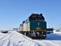 Since it's starting to get a little warm outside (at least in the Hamilton/Niagara region) I thought I'd offer up a little cold and snow photo to remember the winter we just left behind. <br>
Empty flatcar, empty yard, empty grain elevator, empty passenger train! <br>
Arriving as VIA 693 'The Hudson Bay' earlier in the day at 09:00, the consist sits idling in front of the Churchill, MB station. All passengers have detrained, and the last few shuttle vehicles remain gather on the platform to collect the last baggage for delivery to various lodging locations around the town. <br>
In a few short hours at 19:30, this consist will become VIA 690 and will begin its southward journey to The Pas, MB. <br>
In the meantime, I have 9+ hours to walk around the town and railyard looking for some interesting images to capture.