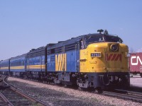 VIA 6767 is eastbound in Komoka, Ontario on August 13, 1982.