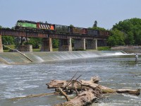 Well, it has been 5 days since the swarming horde of photographers, which I think must have outnumbered the mosquitos, descended upon the little town of Caledonia in order to catch that green BNSF on its run along the Hagersville sub. It almost appears everyone is waiting for someone else to post a photo to Railpictures. So I guess I will do the honours. For those who did not get to witness the action, here is BNSF 2098 and CN 9547 heading south over the Grand River bridge with a few empties to exchange for loads at the CGC (Gypsum plant) at 3rd Line. The train did not continue on to Hagersville, but this day rather just worked CGC and returned to Brantford, with 9547 in the lead.  The whole line is 10 MPH which makes for an easy chase.  CN #580 travels the line here on Mon-Wed-Fri, after 9 AM and before Noon.