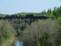 Due to the fact at this time of the year the sun rises so far to the East it was still too early for the right sun angle at the Englehart River bridge in Englehart.  However, this image of the Work Train as taken from the Hwy 11 bridge turned out not too bad.  ONR 1740 and 1741 were heading down to a location near Temagami to pick up a long string (39?) of ballast cars and would be dumping for most of the day. Behind the power is caboose #124, boxcar #2597 (generator, etc on board) and caboose #1873 at the rear.  Beautiful morning.