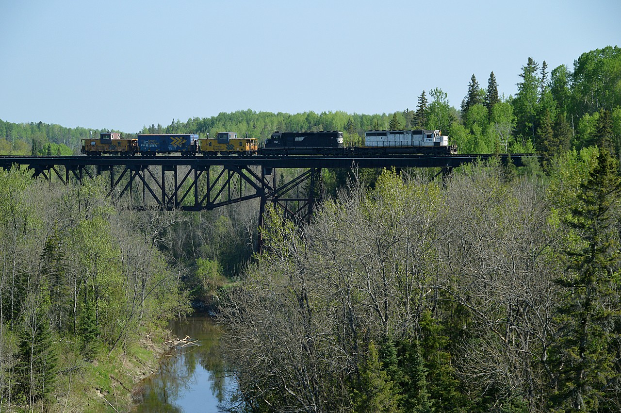 Due to the fact at this time of the year the sun rises so far to the East it was still too early for the right sun angle at the Englehart River bridge in Englehart.  However, this image of the Work Train as taken from the Hwy 11 bridge turned out not too bad.  ONR 1740 and 1741 were heading down to a location near Temagami to pick up a long string (39?) of ballast cars and would be dumping for most of the day. Behind the power is caboose #124, boxcar #2597 (generator, etc on board) and caboose #1873 at the rear.  Beautiful morning.