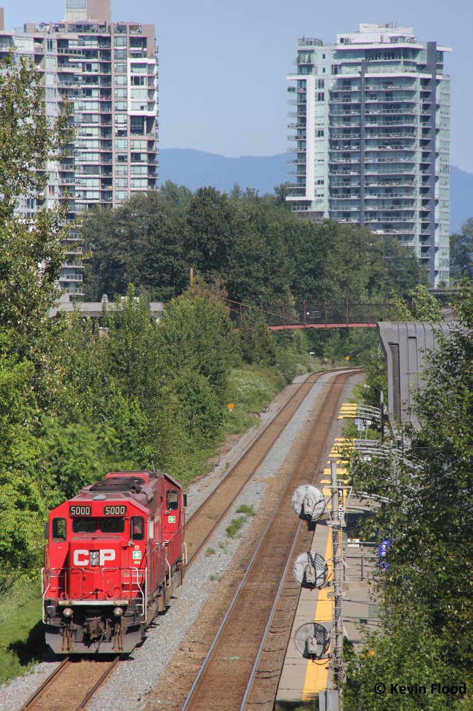 My family and I checked out a new area in the Vancouver area today and came across this power switching Pacific Coast Terminals in Port Moody, BC, which appears to be a sulphur loading site. The power is pictured resting beside the Moody Centre Skytrain station. It was a beautiful afternoon out and Rocky Point Park was popping. Power was CP 5000-CP 6245.