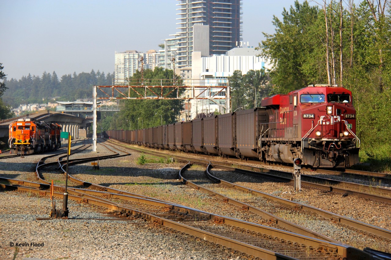 A loaded CPKC coal train is on the approach to Brunette in New Westminster, BC as it passes through the BNSF New Westminster Yard and depot. Power was CP 8734-CP 8109-CP 8080 in a 1-1-1 setup.