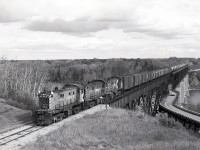 CP used to service its White Fox subdivision with a crew and typically three lightweight RS-23s from Prince Albert, heading north on CN running rights for 18 miles to a junction at Sharpe, then east on CP rails picking up grain loads from elevators.  After exchanging loads for empties and wyeing the units at Nipawin at mile zero, westward they went, peddling empties at elevators through to Meath Park, then cab hop to Sharpe at mileage 73.4 and south on CN back to Prince Albert.

<p>Seen on Wednesday 1981-09-23 at 1353 CST, CP 8018 + 8016 + 8014 are wheeling the empties across the Saskatchewan River (71 km as a crow flies downstream of the confluence of North and South branches) bridge at mileage 1.6 just west of Nipawin, a crossing then shared with old highway 37 on a lower deck, but now closed to road traffic.  The railway there is now Torch River Rail, and extends westward only to mileage 27.2 at Choiceland.