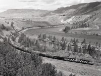 Right at the west switch of Walhachin, CN’s close association with the Thompson River is very evident as long symbol train 414 powered by SD40s 5120 and 5176 heads eastward at 0929 PDT on Tuesday 1987-06-02.