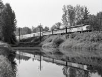 Just east of Haney in Maple Ridge, CP’s mainline crosses Kanaka Creek at mileage 101.5, and the generally smooth water surface provides reflecting opportunities.  As seen on Monday 1989-08-07 at 1004 PDT, VIA No. 1 powered by VIA 6307 + 6602 + 6603 was about half an hour behind scheduled time, still with 30 miles to Vancouver.