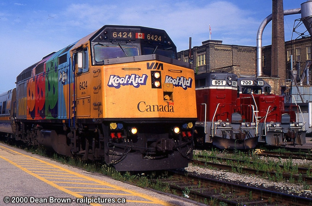 84 with VIA F40PH-2 6424 Kool-Aid and GEXR 901 and 700 in Kitchener, ON.