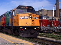 84 with VIA F40PH-2 6424 Kool-Aid and GEXR 901 and 700 in Kitchener, ON.