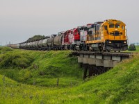 Ever outpaced a Dash 7 on a bicycle? That would be the story of this little operation of mine in recent weeks. The most recent episode of this little gem being reactivated by SSR since its last action in 2020 (Check out Matt Watson's captures of its previous activity <a href="http://www.railpictures.ca/upload/while-i-was-kind-of-bummed-that-the-stewart-southern-railway-had-no-cars-on-the-return-trip-out-of-regina-a-b23-7-on-the-road-in-2020-is-definitely-worth-a-shot"> http://www.railpictures.ca/upload/while-i-was-kind-of-bummed-that-the-stewart-southern-railway-had-no-cars-on-the-return-trip-out-of-regina-a-b23-7-on-the-road-in-2020-is-definitely-worth-a-shot </a> ) began roughly sometime in April when some other attendees at Railfest Regina spread the word about the B23-7 being active once more. Being pre-occupied with my summer job here in Regina and a healthy flow of Albertan work trains from Winnipeg in May, it took me until June when I began placing the SSR in my crosshairs as this trio had been sitting in Regina shops for almost 2 weeks straight. 
<br> <br> 
Having just missed an outbound run to Stoughton a couple of days prior and the thought that weekend runs weren't a possibility due to the nature of shortlines hiring retired Class 1 crews, I was blissfully out shooting CN local power at the other end of town on my bike when I heard SSR call the Assistant Trainmaster to work Regina. I quickly concluded my CN activities and rode a tailwind across the city with a small detour by the shops to confirm my suspicion. I then continued to my first planned spot on Highway 33 which runs parallel to the Tyvan Subdivision, where I posted to wait them out. Realizing that track speed is 10mph, and that my bike just averaged 20mph getting to the first spot after shooting it, I decided to make chase and beat them to Richardson where they terminated, just 2 mileposts away. During this rush to pack up my equipment, I accidentally destroyed my radio scanner earphones, snagging them on the bike chain and I even had a small wipeout pulling into Richardson due to the gravel road consisting of a looser grade of gravel. The bike was temporarily incapacitated with the chain coming off so I briefly abandoned my bike while I ran off to grab this frame. Just another fun adventure with a pay-off in the end for the books. By the time I returned to Regina, my mileage that day totaled 64km.