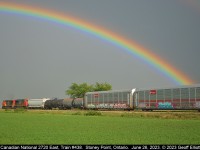 Somewhere 'under' the rainbow.  CN (IC) 2720 leads train #438 eastbound as it nears Stoney Point, Ontario on June 26, 2023.  With on/off rain most of the day we were seeing open skies inbetween the showers.  As luck would have it I happened to hear 438 approaching Belle River and was able to get far enough ahead of the train to get a nice going away shot with one of the most brilliant rainbows I think I have ever seen included.  I've always said, "I'd rather be lucky than good"....  :-)