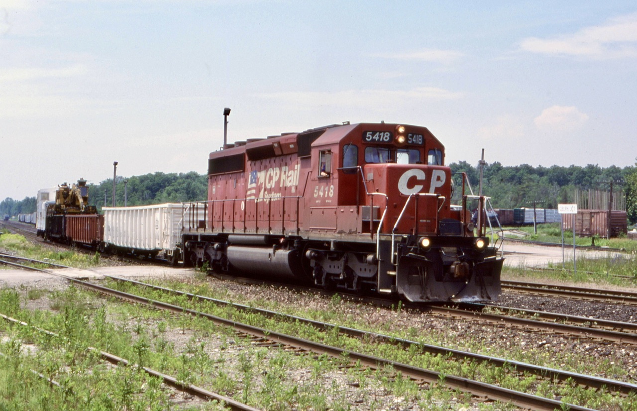 Almost 22 years ago, CP 5418 a former KCS SD40-2 was assigned to tie train service. After a busy day it has returned to Guelph Junction for the night. Today high rail trucks typically hold down this kind of work.