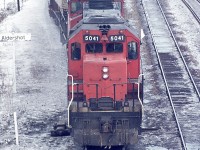 Back before all the modern GO/VIA facilities were built here, the view looking east off of the Waterdown Rd bridge in Aldershot was of a long yard on the north side. This image shows CN 5041 and 9459 pulling out onto the north main with some TOFC up front, general freight in behind.  It has been quite a few years since we have seen trailers on flat cars over either CN or CP.
The SD-40 5041 went off roster in 1999 and was rebuilt to a SD40-2 for BNSF according to the Cdn Trackside Guide.
As for the wooden Aldershot namesign.........it SHOULD be in my garage, but, alas, it isn't. 