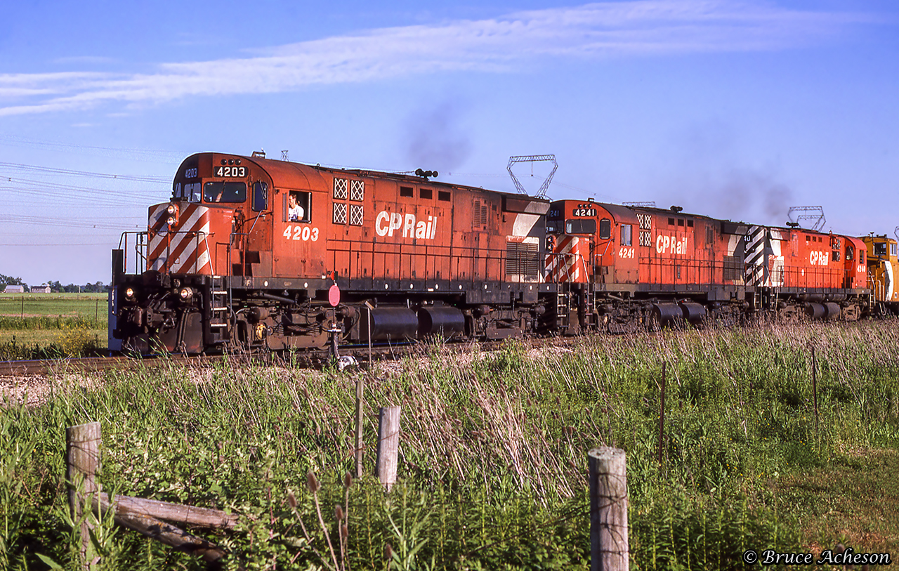 Canadian Pacific's steel train is northbound across the Cayuga Sub at CN Garnet with three MLW C424s taking charge.  Upon reaching Hagersville, the train will reverse onto the CASO, making the run east to Welland to get back to Hamilton over the TH&B.