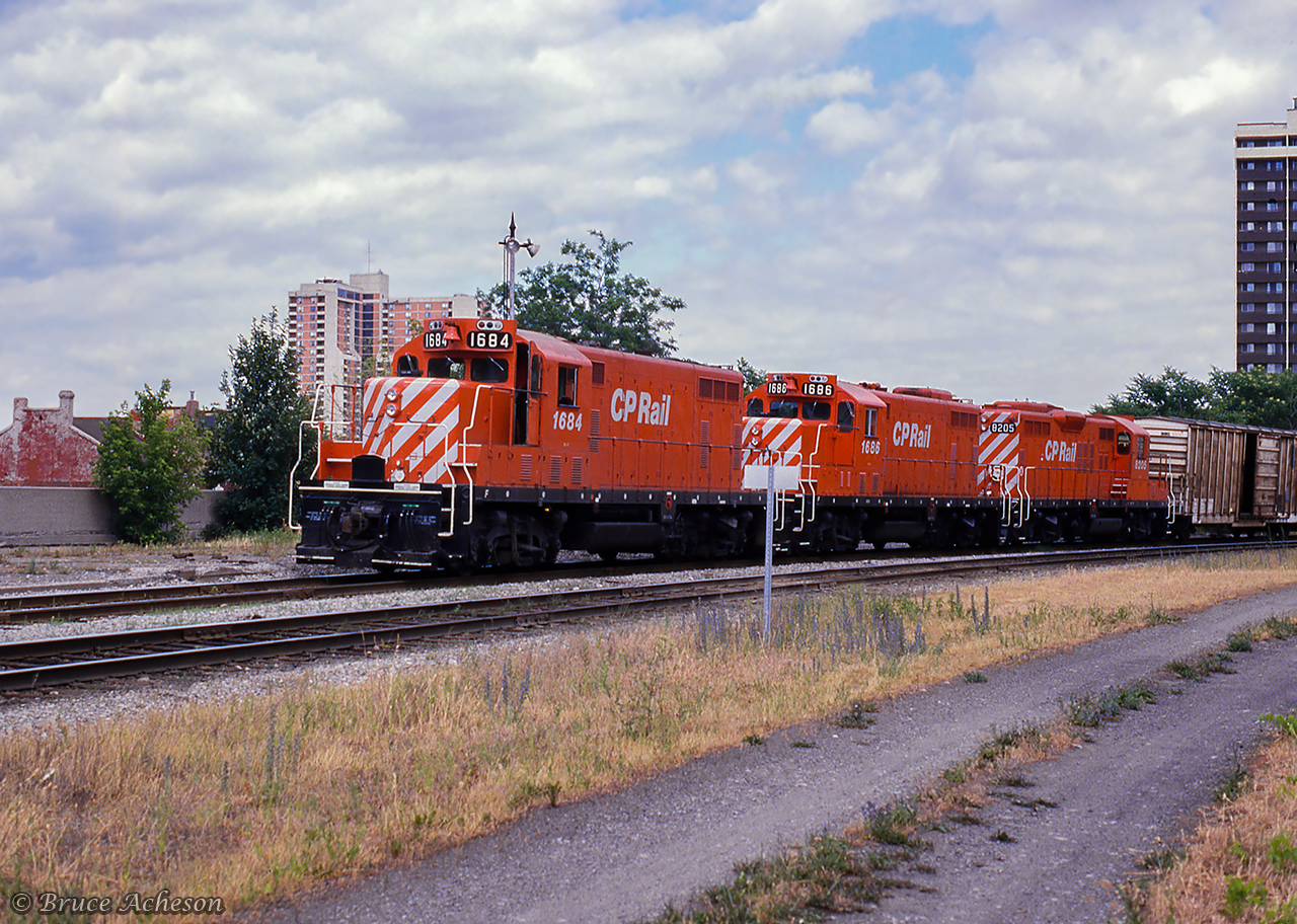 Three of CP's recently rebuilt GP units, two being former Toronto, Hamilton & Buffalo units, approach Hunter Street station.  All three units would survive until the end of the GP7/9 era on CP in the mid 2010s.  CP GP7u 1684, former TH&B 74, emerged from rebuild just one year earlier, would be retired in 2013.  Second up, CP GP 7u 1686, the former TH&B 76, would be retired in 2012.  Finally CP8205, originally, CP 8648, would be retired in 2014.