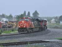A tropical downpour is taking place as a CN freight pulls out of Capreol, Ontario on June 30, 2018.  Power for the train is CN 2226 2515 and CEFX 6007