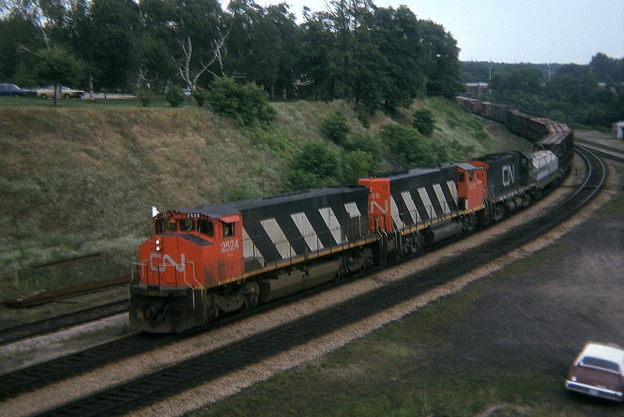 One of my early efforts, summer 1974 showing CN 2524, 9458 and 3224 heading westbound thru the junction and up onto the Dundas sub. Variety was what it was all about back then, before the onslaught of the hundreds of  GP40-2L ( example: #9458) locomotives that came on the scene in the latter half of 1974 thru 1975.