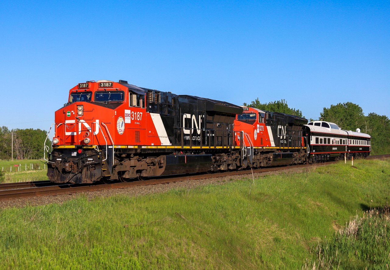 CN P 00851 06, the President's Train celebrating Safety Week blasts through Uncas, Alberta on the first leg of the trip to Winnipeg.  The consist was CN 3187, CN 3275, both sporting Zero is Possible decals, CN 99; American Spirit and IC 800413; Great Lakes.