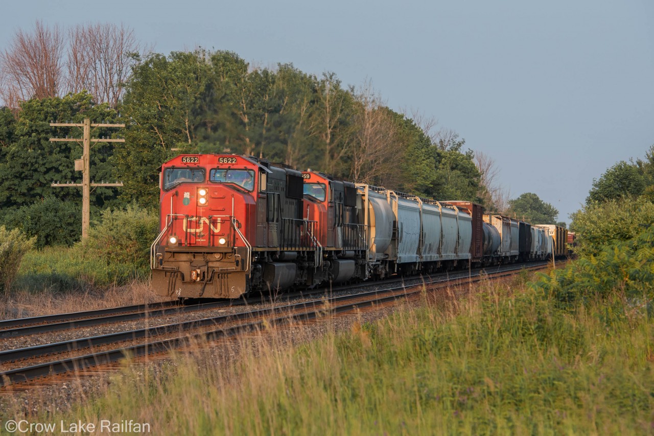 The tranquil morning is broken by the sound of two EMD's thundering through Newtonville bringing mixed freight to Montreal.