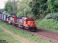 A CN eastbound with SD40u 6013 and SD40-2 5379 is viewed curving through the town of Paris approaching the John Avenue overpass as it heads to Hamilton on the CN Dundas Subdivision. 