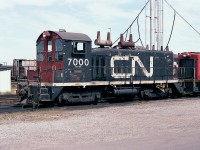 When thinking of CN 7000 series, first comes to mind are the GP9RMs. Almost forgotten now are the 7000-7009 series of GMD SW-9 switchers that arrived on CN during 1952 and 1953. A few of the bunch were later renumbered into the 7700 series, but life was unkind to the first of the lot....CN 7000. It was retired a year after this photo was taken; gone from the roster by late December 1984..
It is looking a little worse for wear as seen here at the old Stuart St yard diesel facility down on the Hamilton waterfront.