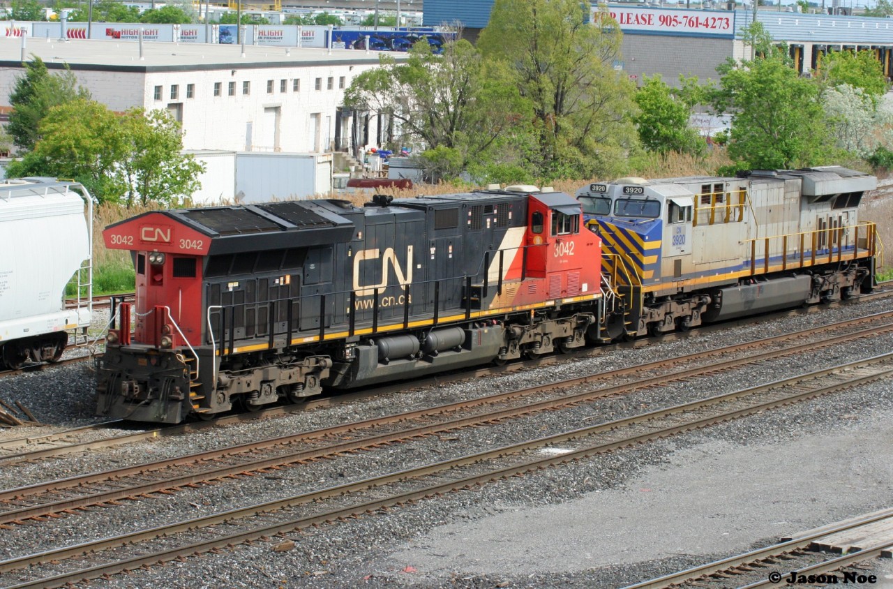 Light power CN 3042 and CN 3029 drifts into CN's MacMillan Yard in Vaughan, Ontario just north of Toronto, seen from the Highway #7 overpass. June 5, 2022.