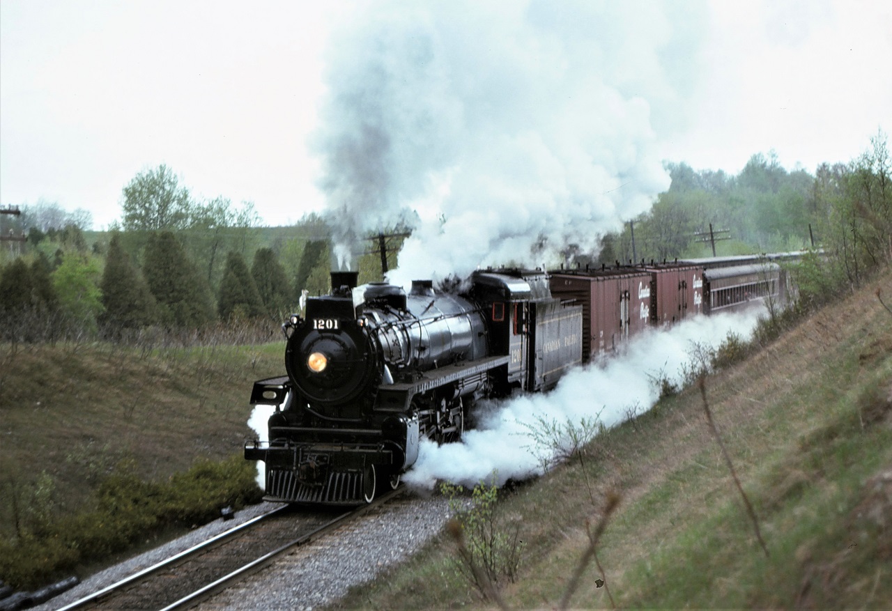 Former CP 1201 leads a 5 car excursion train back to Toronto near Dranoel, Ontario on May 16, 1976.